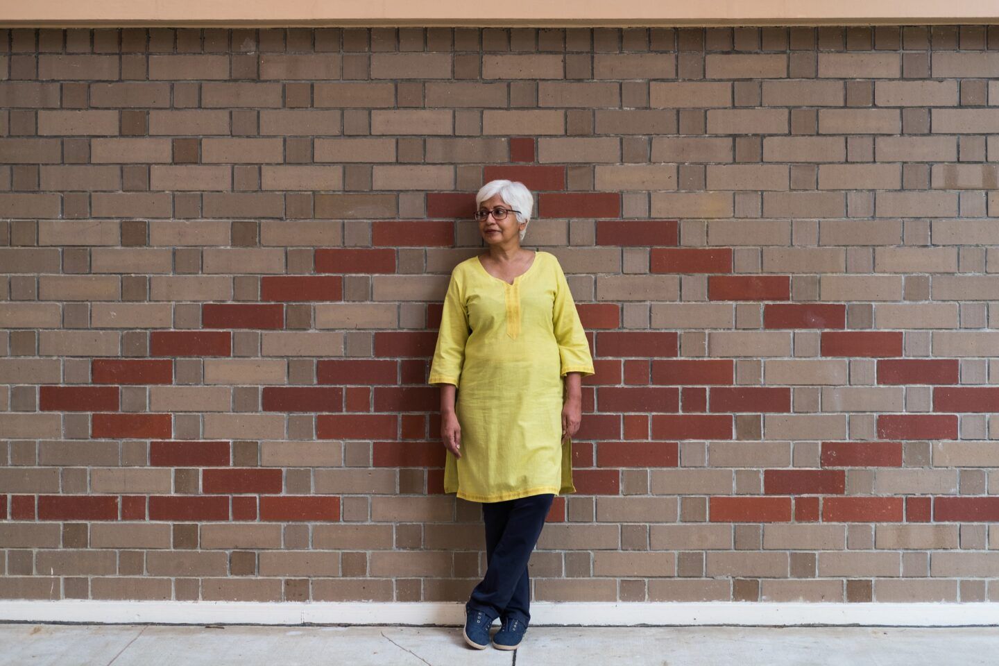 Woman leaning against a wall