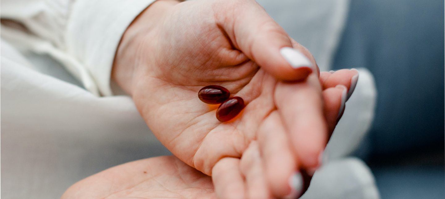 vitamins in palm of a hand