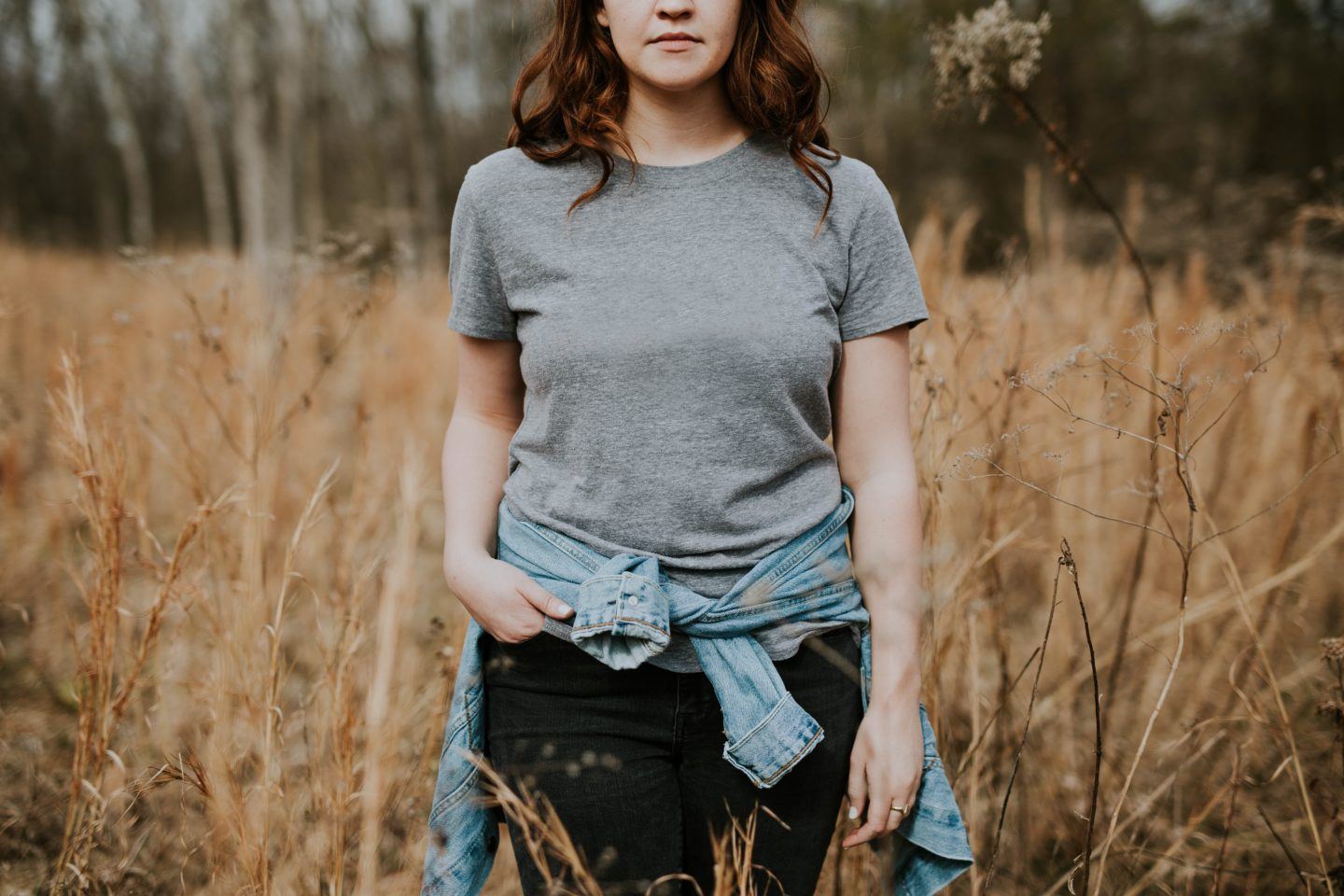 Woman in t-shirt standing in field