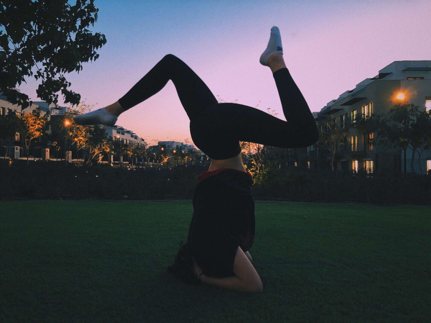 pilates stretch on a sunset lawn