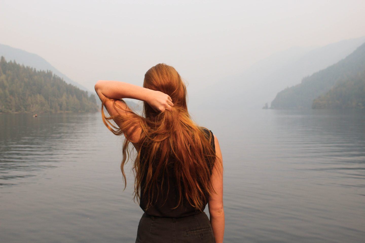 Woman looking out over a lake