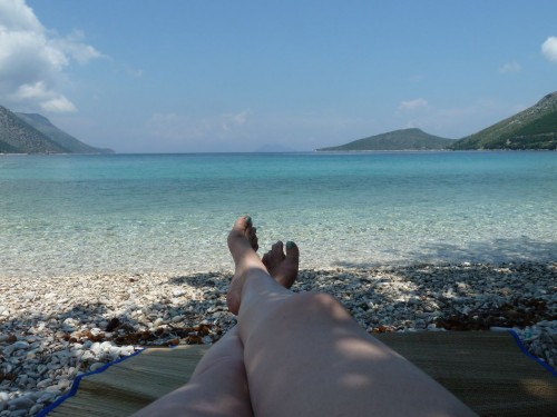 The author of this blog's toes on a rocky beach in Greece 