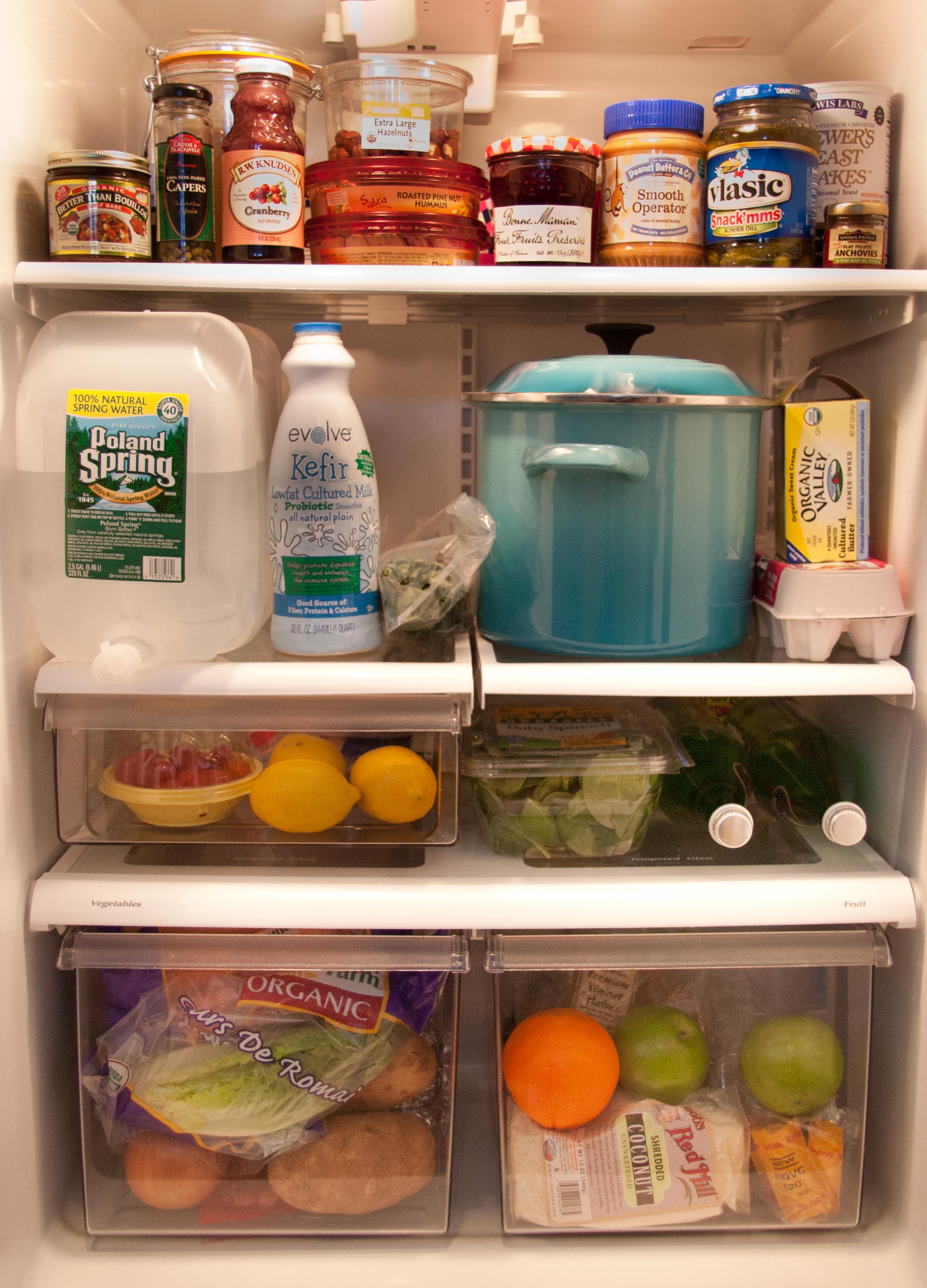 the inside of a well stocked fridge 