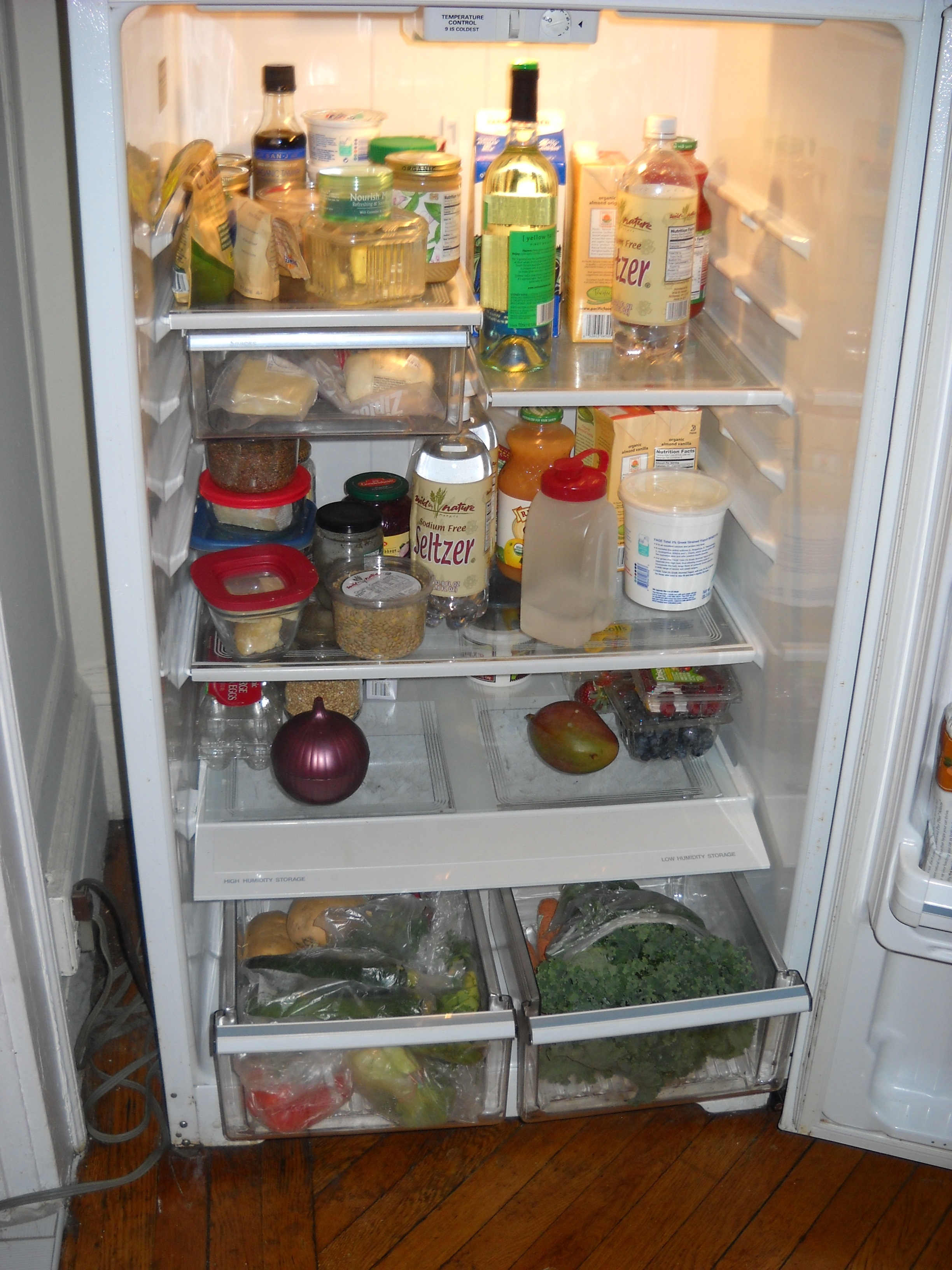 An open, well stocked fridge