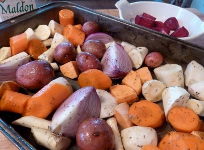 cut up carrots, onions, and parsnips on a baking tray