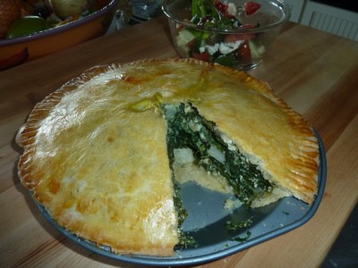 Photo of leafy green pie cut open