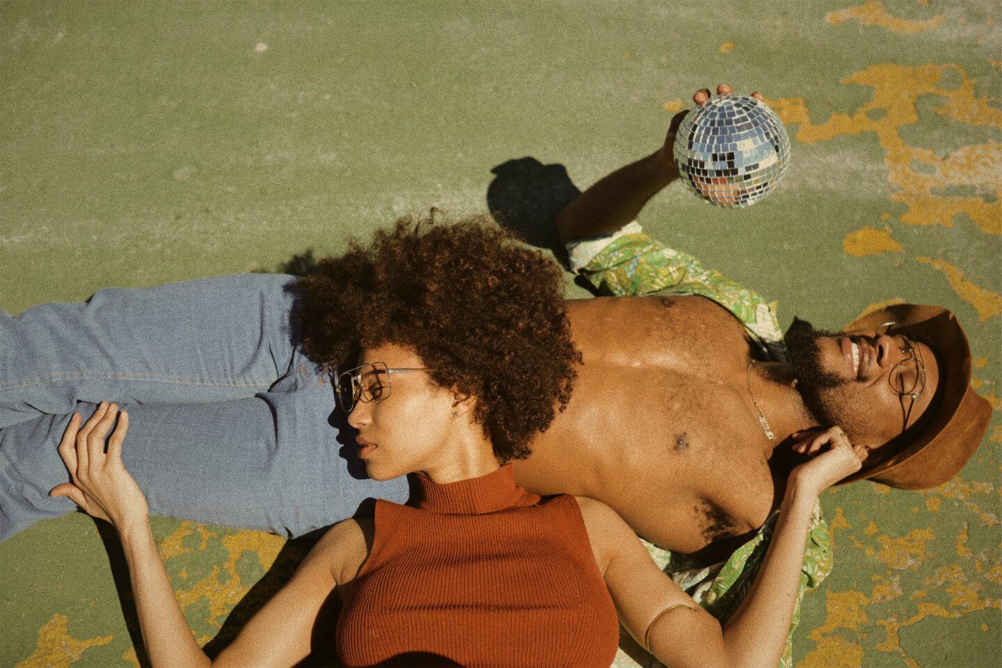Two people laying together outside, taking in the sunshine and enjoying the day