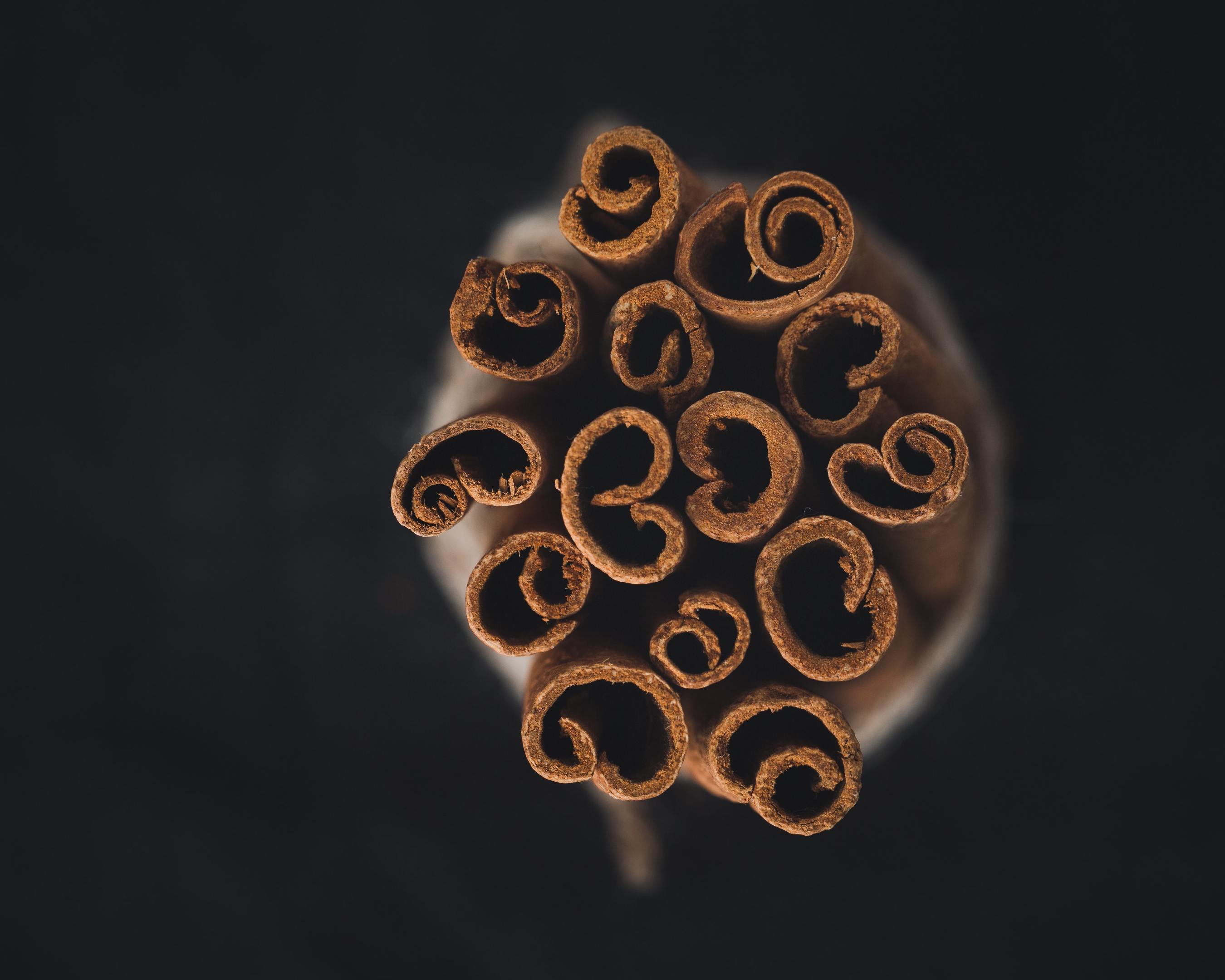 A bundle of fragrant cinnamon sticks on a black background