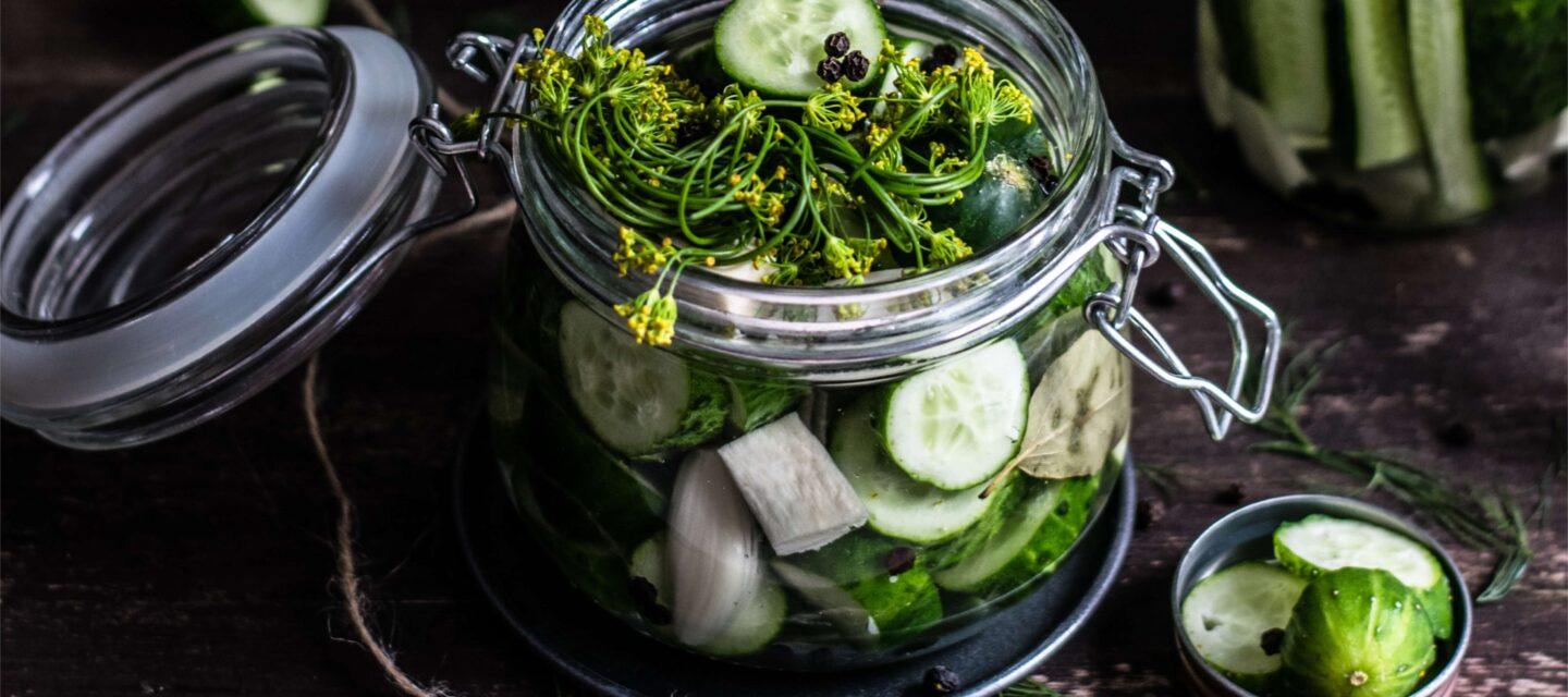 a jar full of fresh green vegetables ready to be pickled