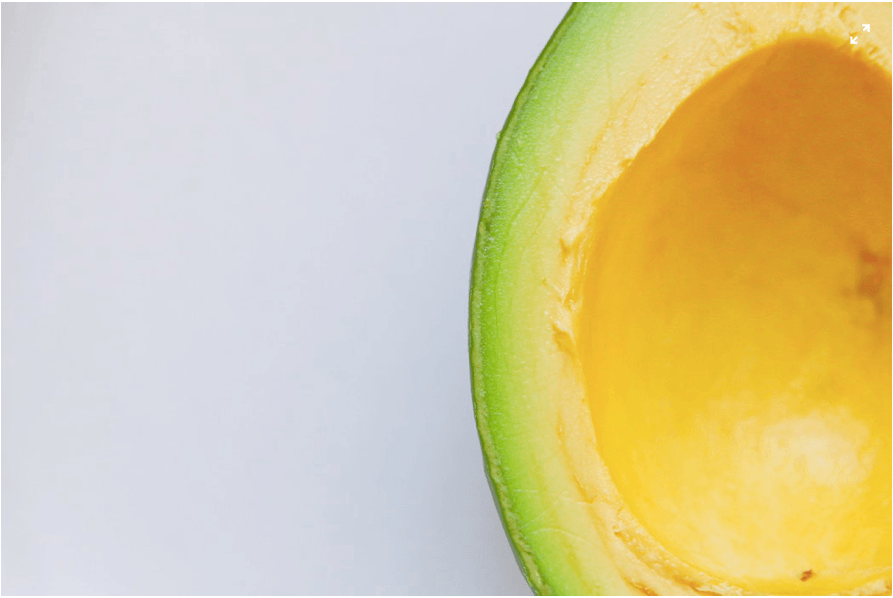 a very close up shot of a cut open avocado