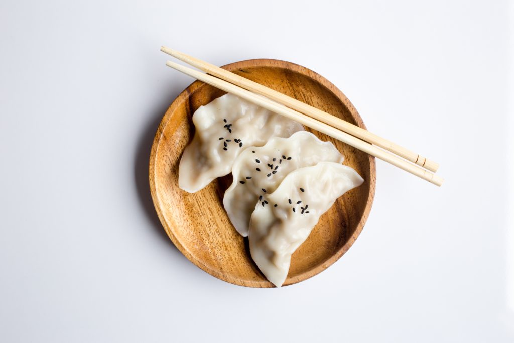 dumplings on a plate with chopsticks