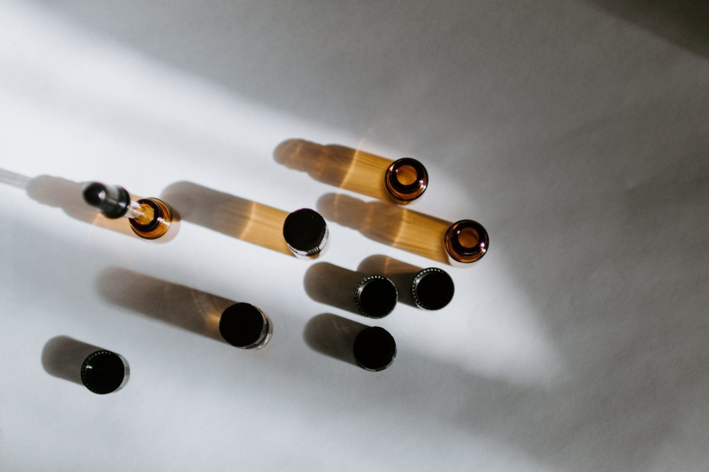 empty herb bottles and unscrewed caps resting on a white table