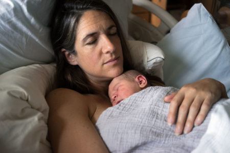 Mother snuggling her newborn baby