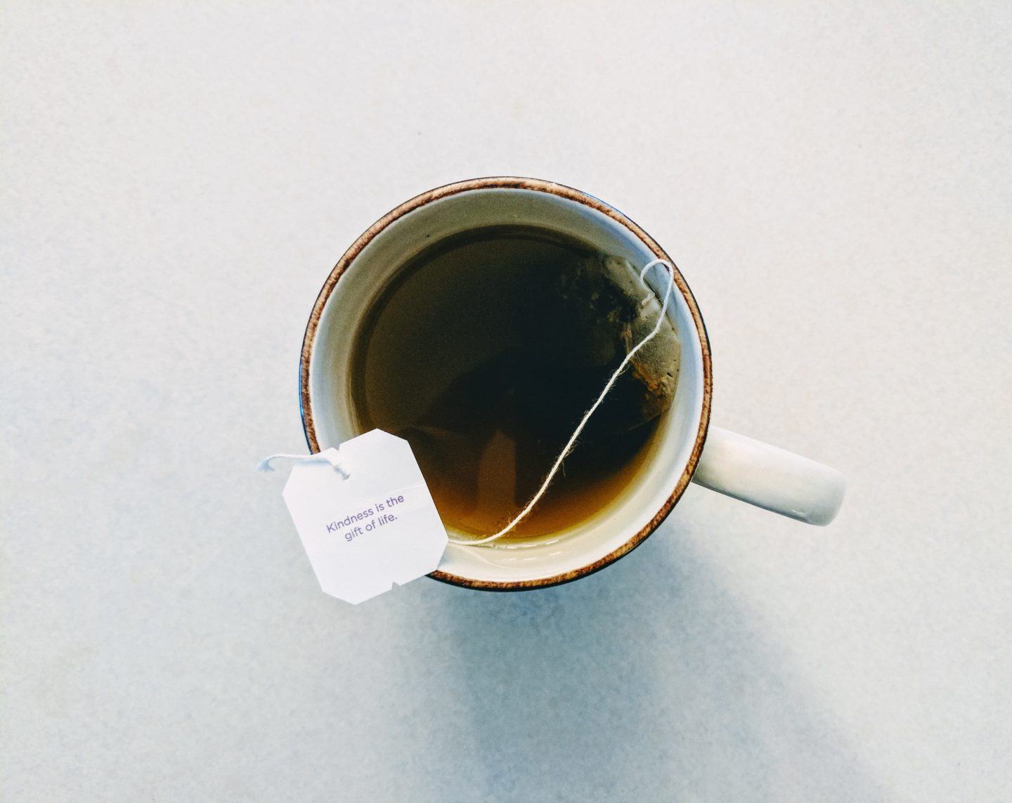 Cup of tea with tag that says "kindness is the gift of life."