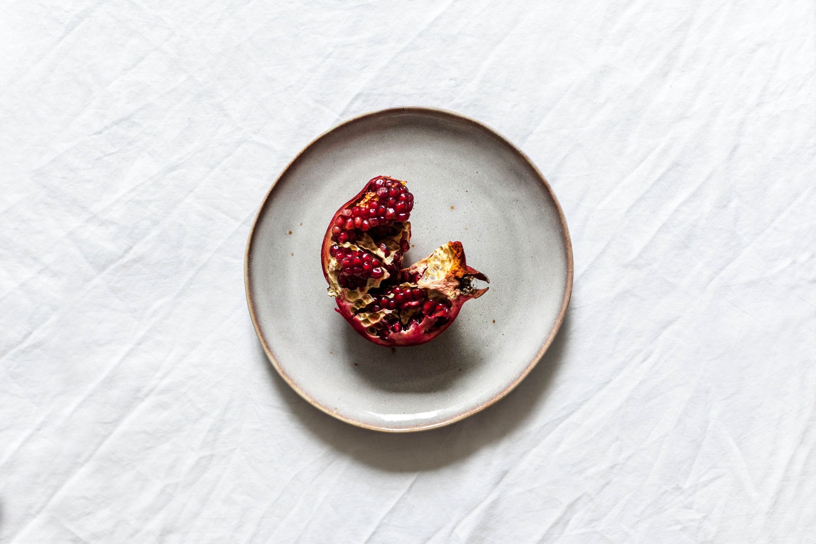 pomegranate on a ceramic white plate
