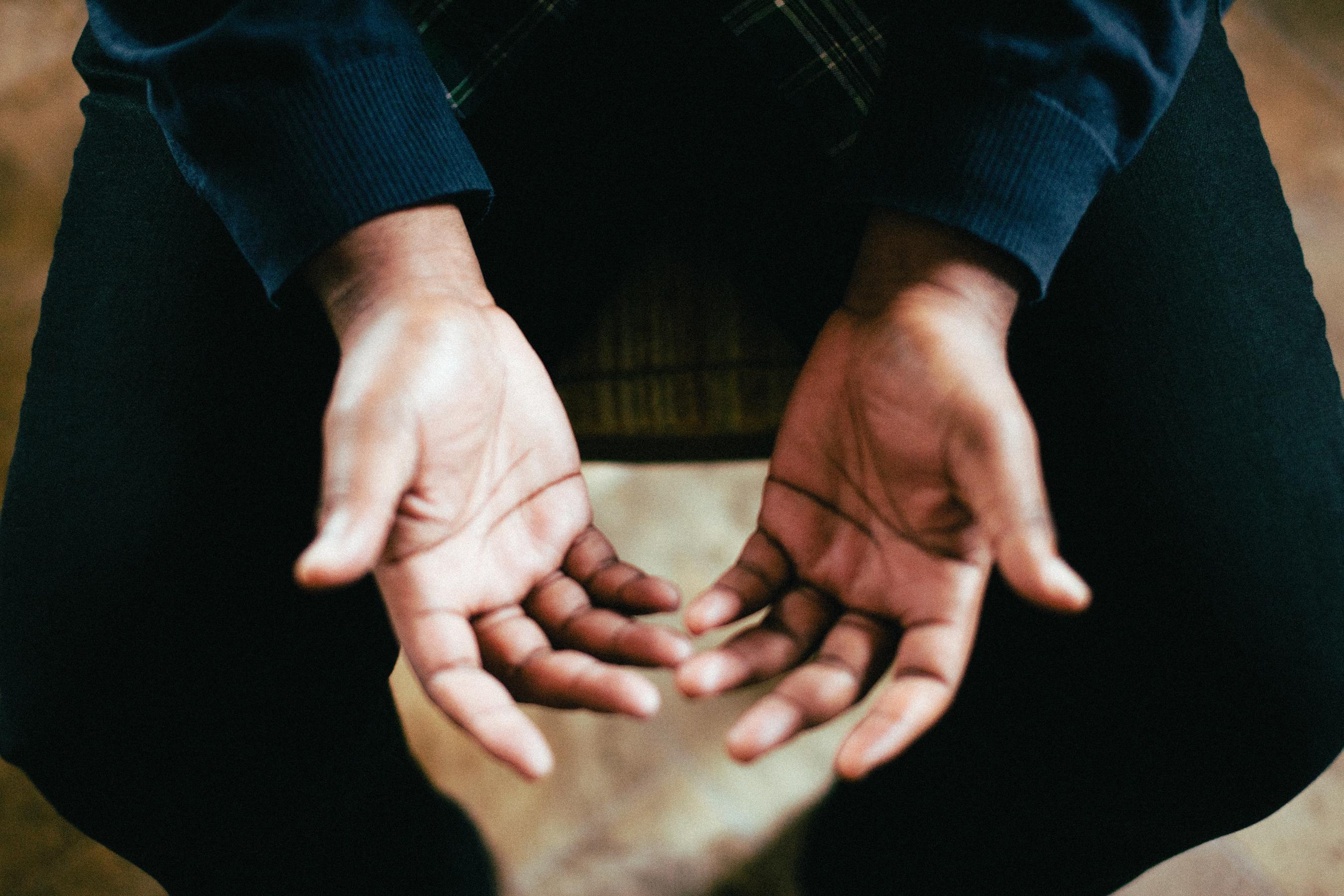 person holding their hands open, ready to apply pressure to acupuncture points