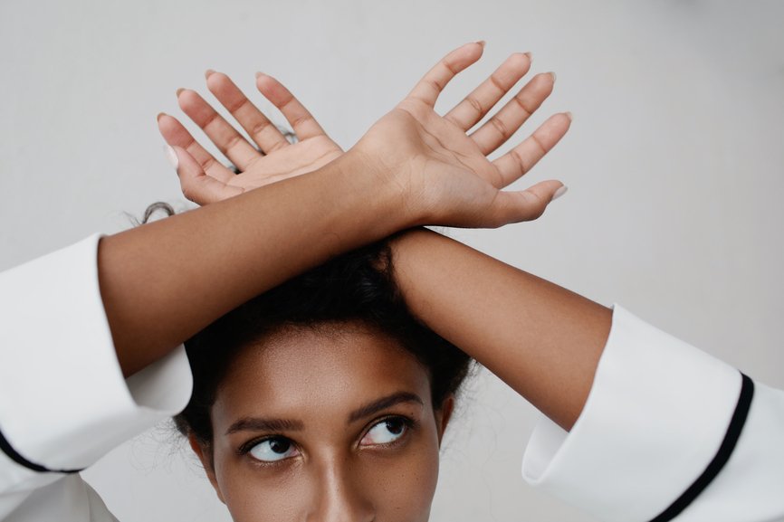 black woman with her hands crossed resting on her head