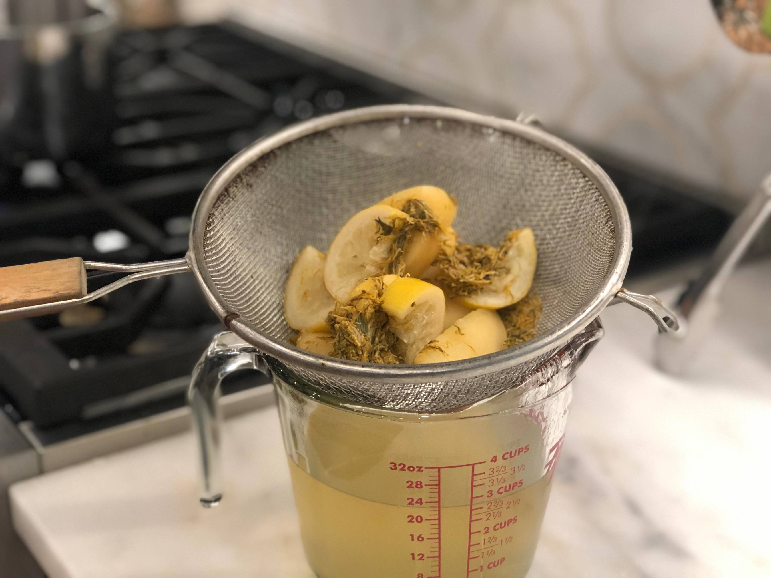 lemon and cooked dandelions strained into a measuring cup