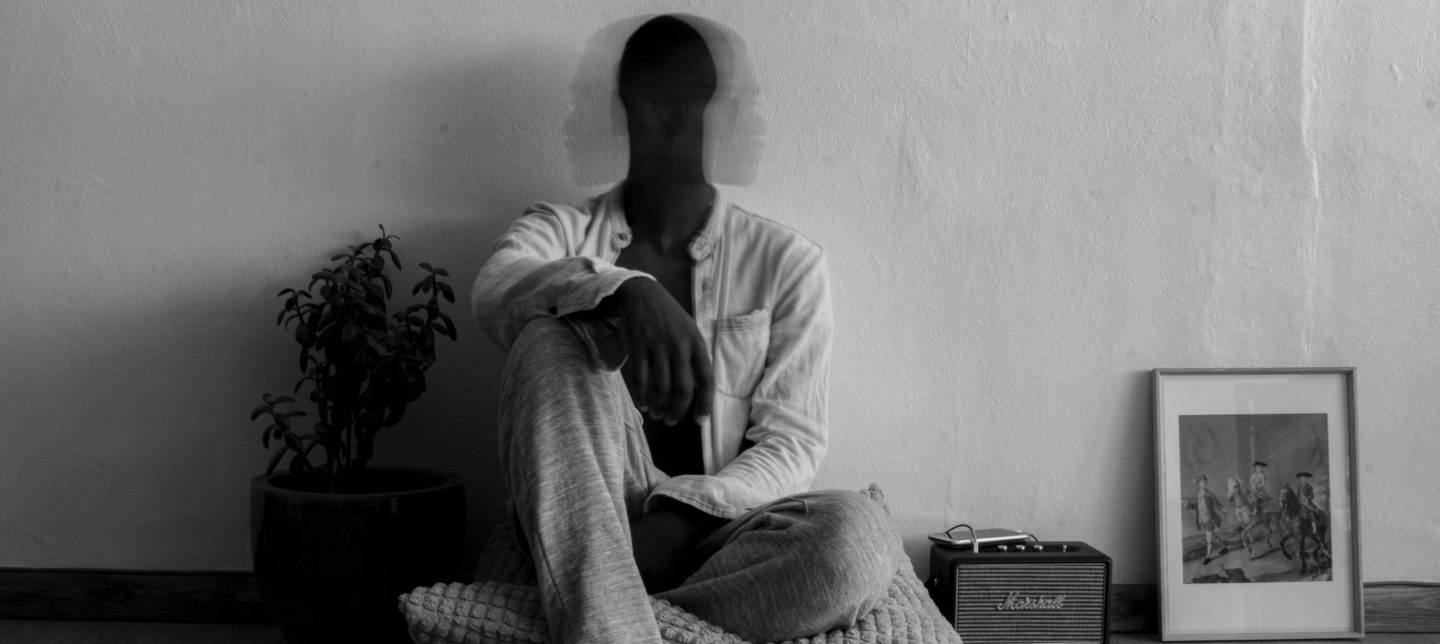 man sitting on a cushion