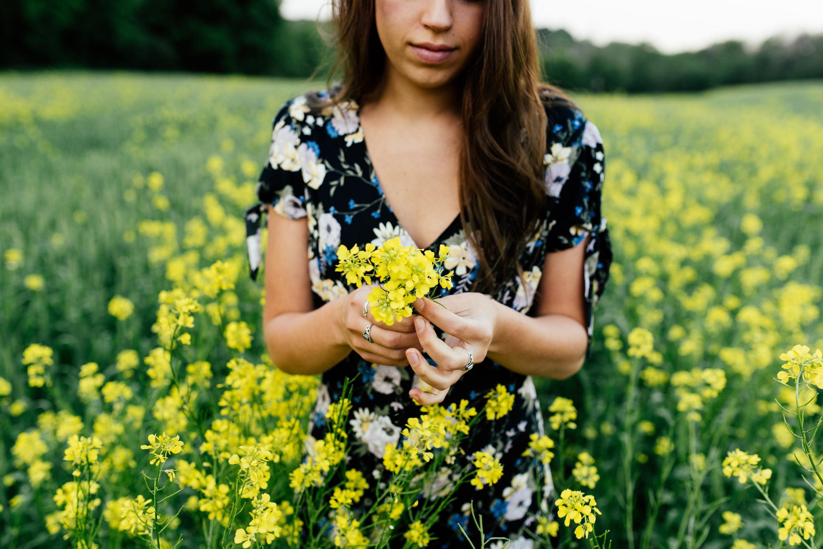Woman in field holding flowers