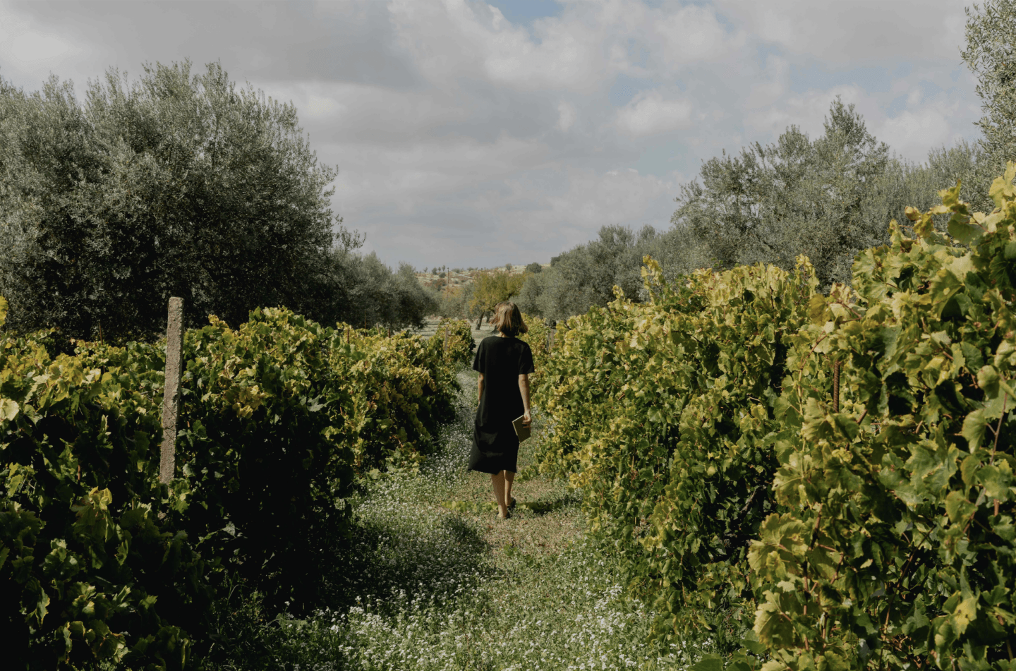 woman walking through a field