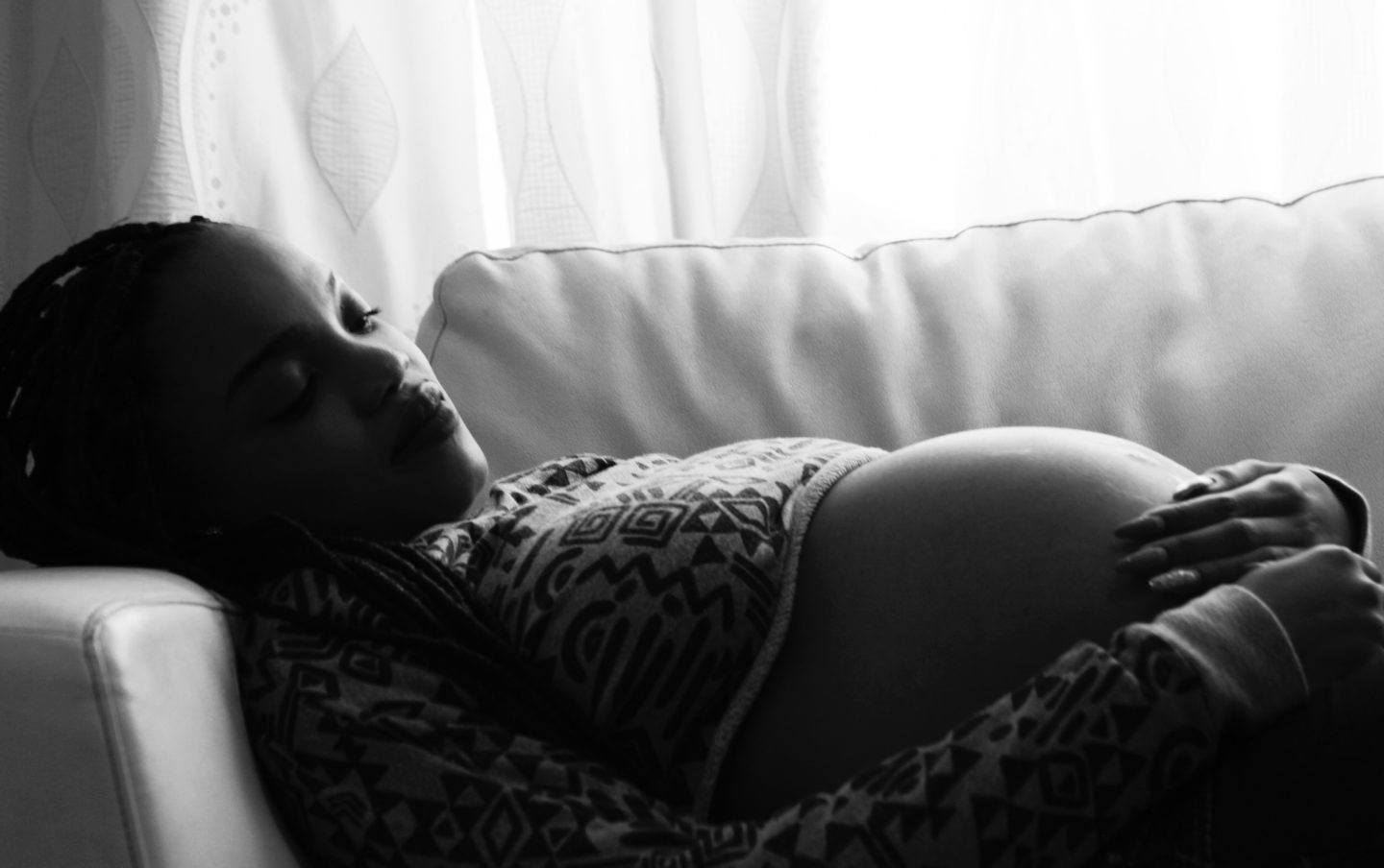 Pregnant woman laying on the couch