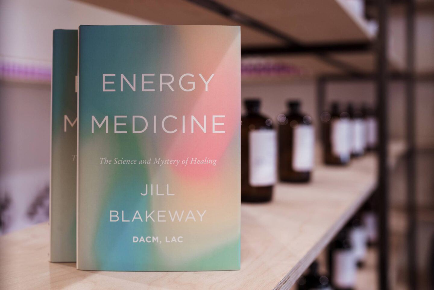 The Energy Medicine book on a shelf with tincture bottles