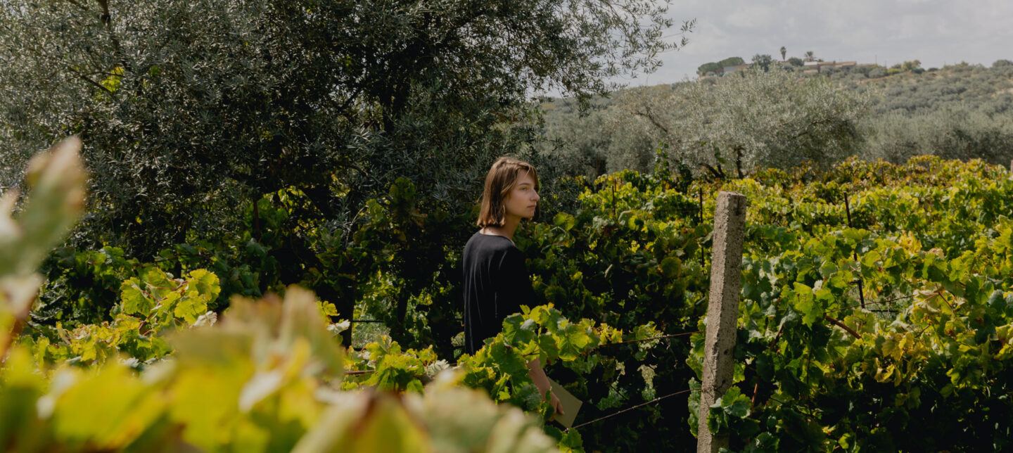 Woman standing in a maze of greenery