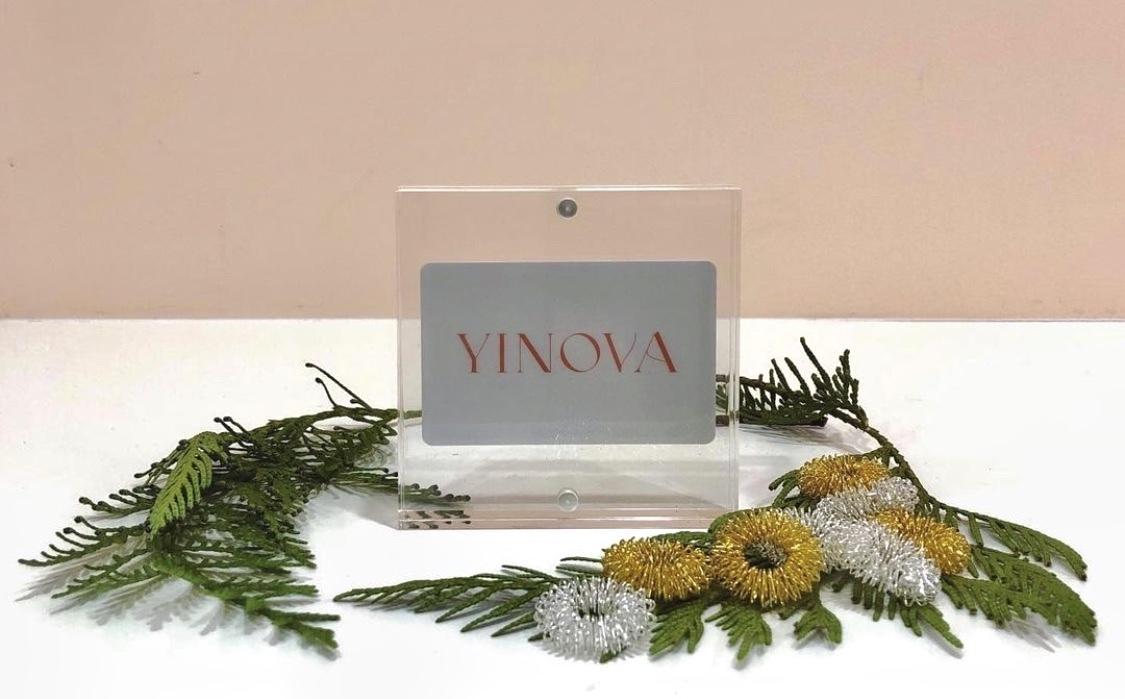 a Yinova gift card surrounded by acupressure rings