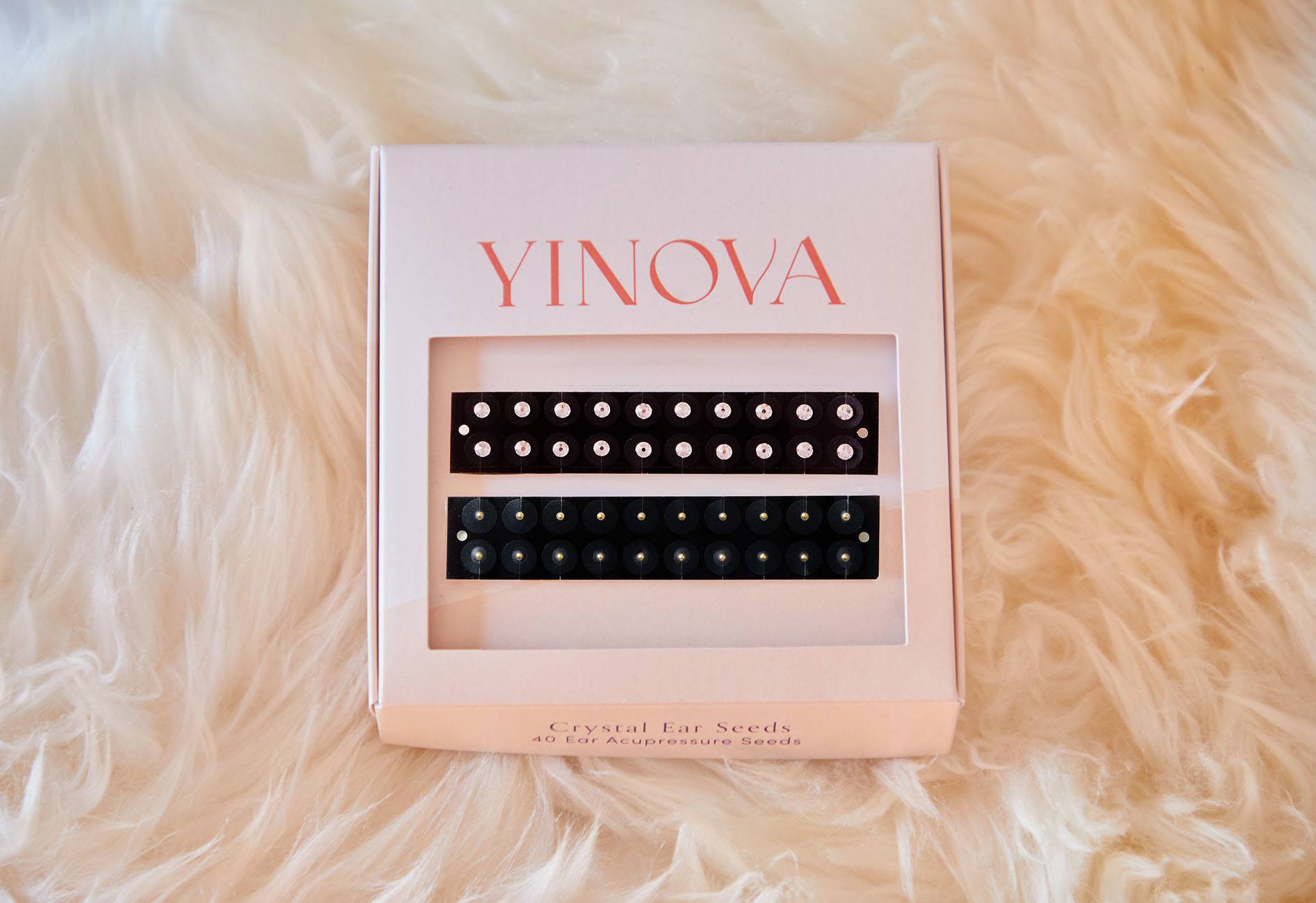 Yinova's Ear Seed kit atop a blackest of white faux fur