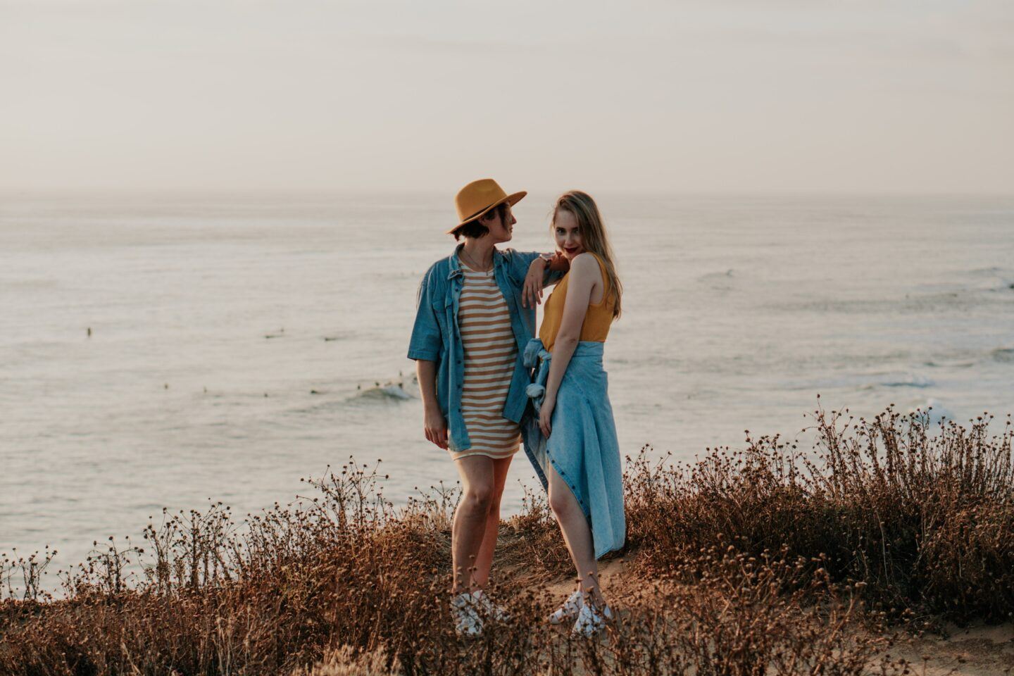 Two friends stand on a beautiful cliff side