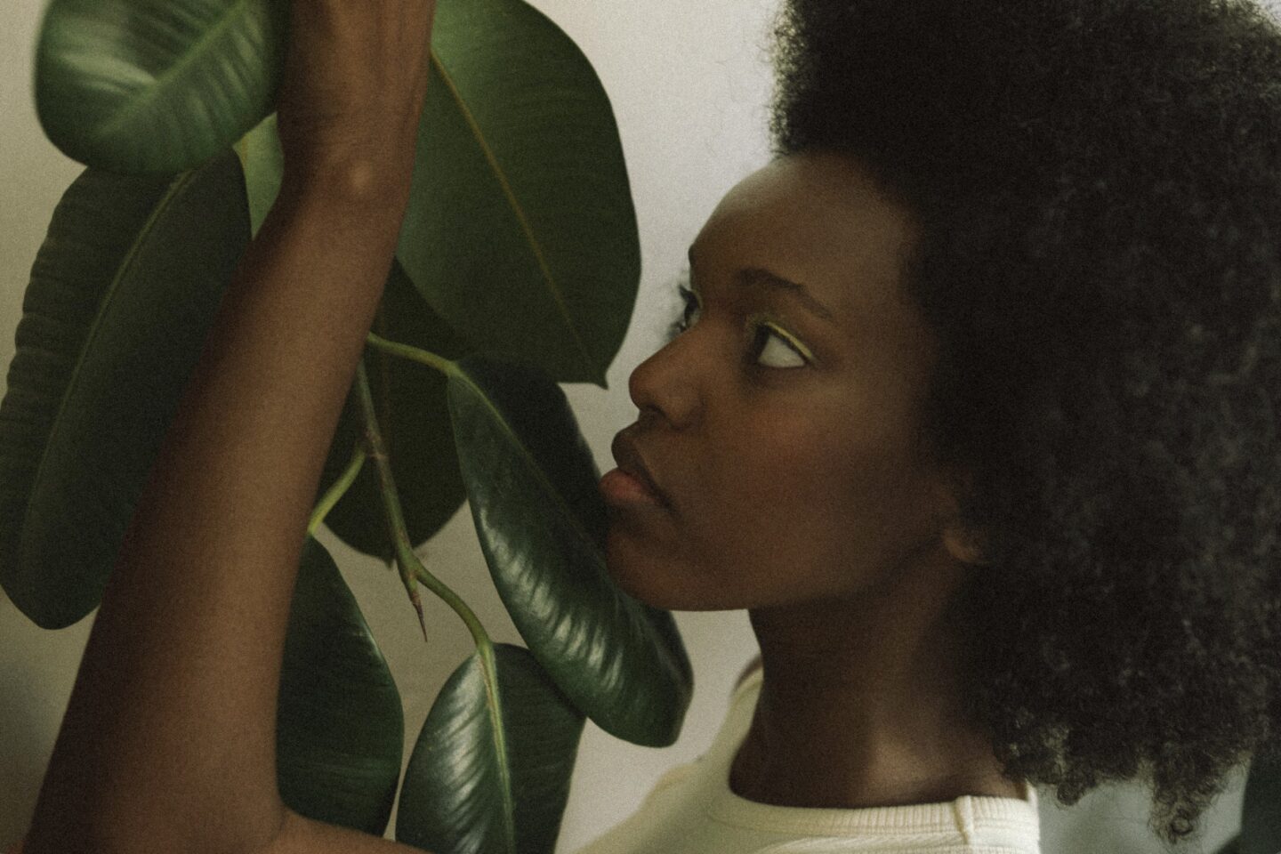 Woman surrounded by plants representing holistic fertility care, acupuncture, and preparing the body for conception during the premester.